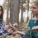 girl-taking-something-from-branch